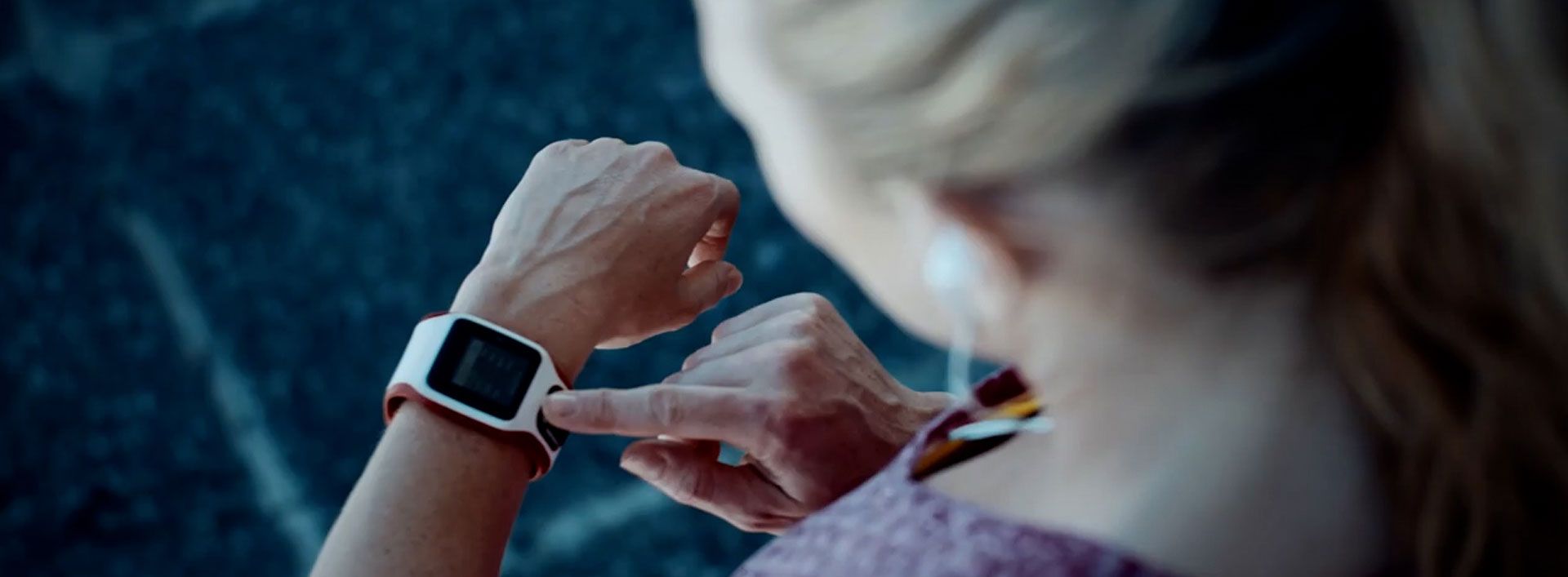 Runner looking at fitness tracker on wrist