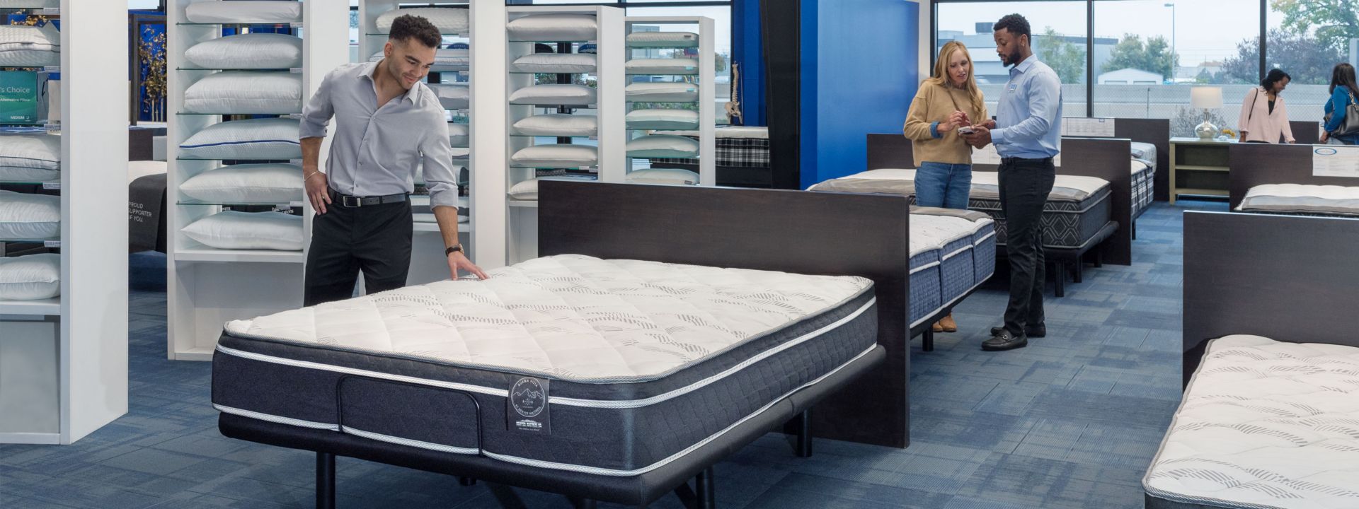 Buena Vista Mattress in Store with shoppers. 