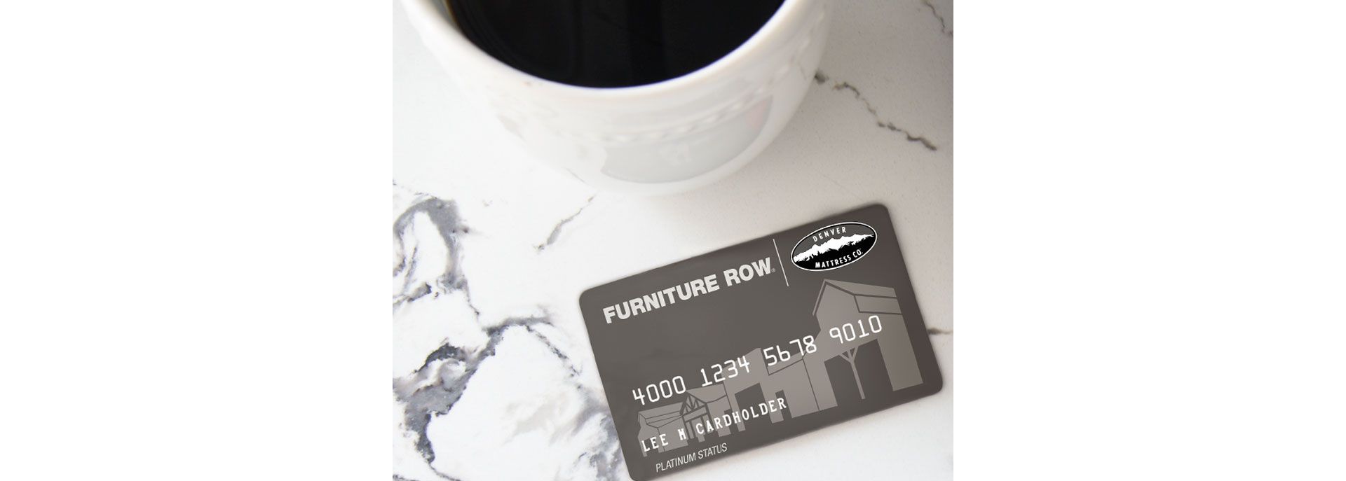 Furniture Row Credit Card Next to computer with coffee cup