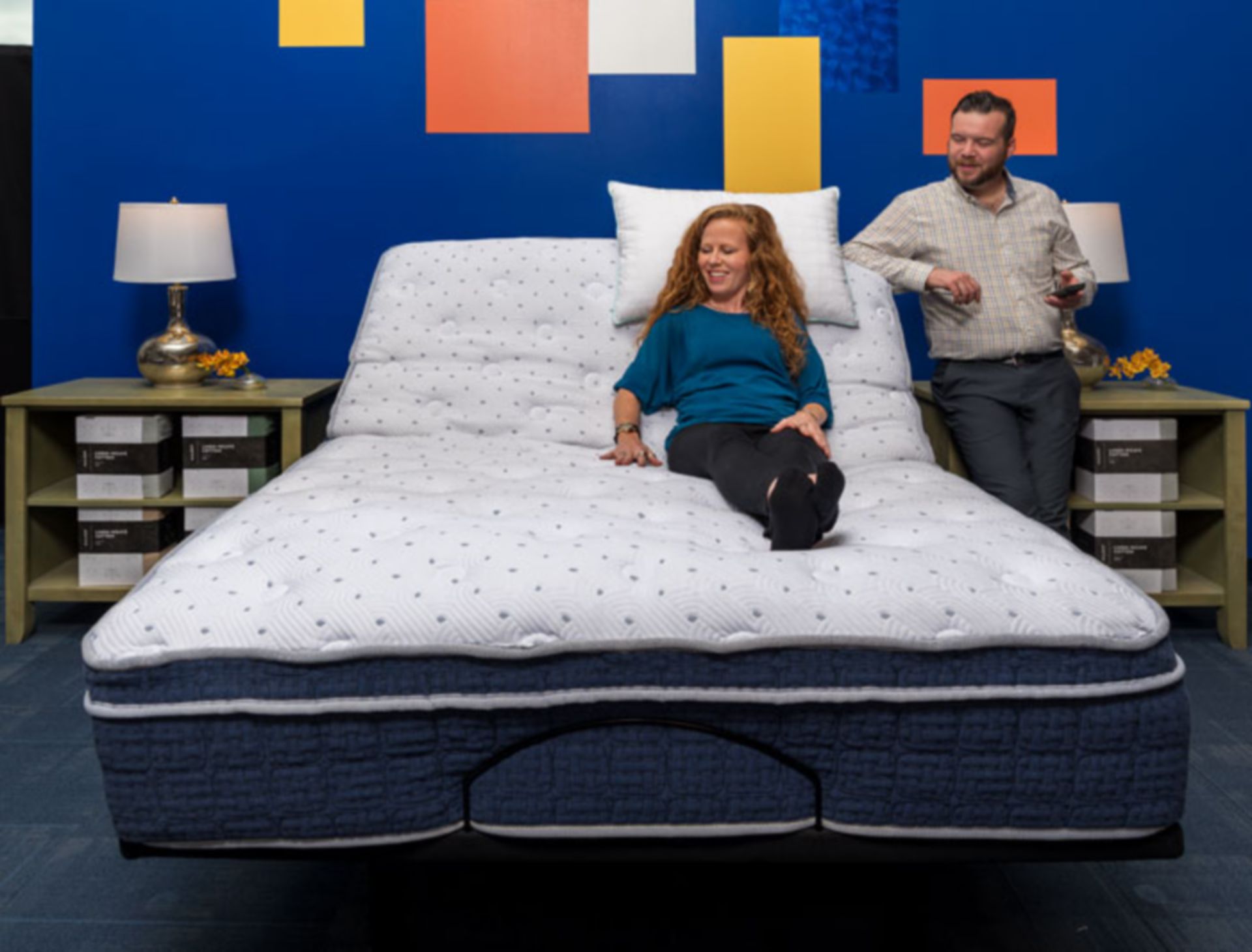 Couple testing adjustable base in denver mattress store