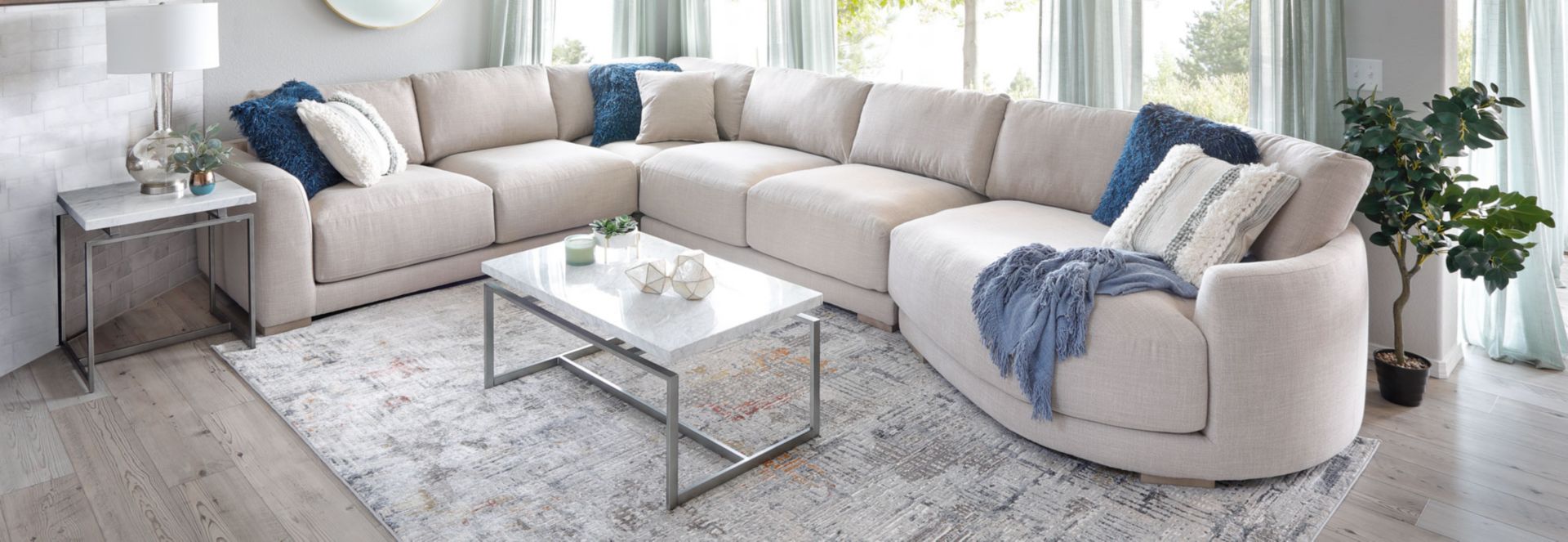 Light Grayish tan L shaped sectional with curved chaise 