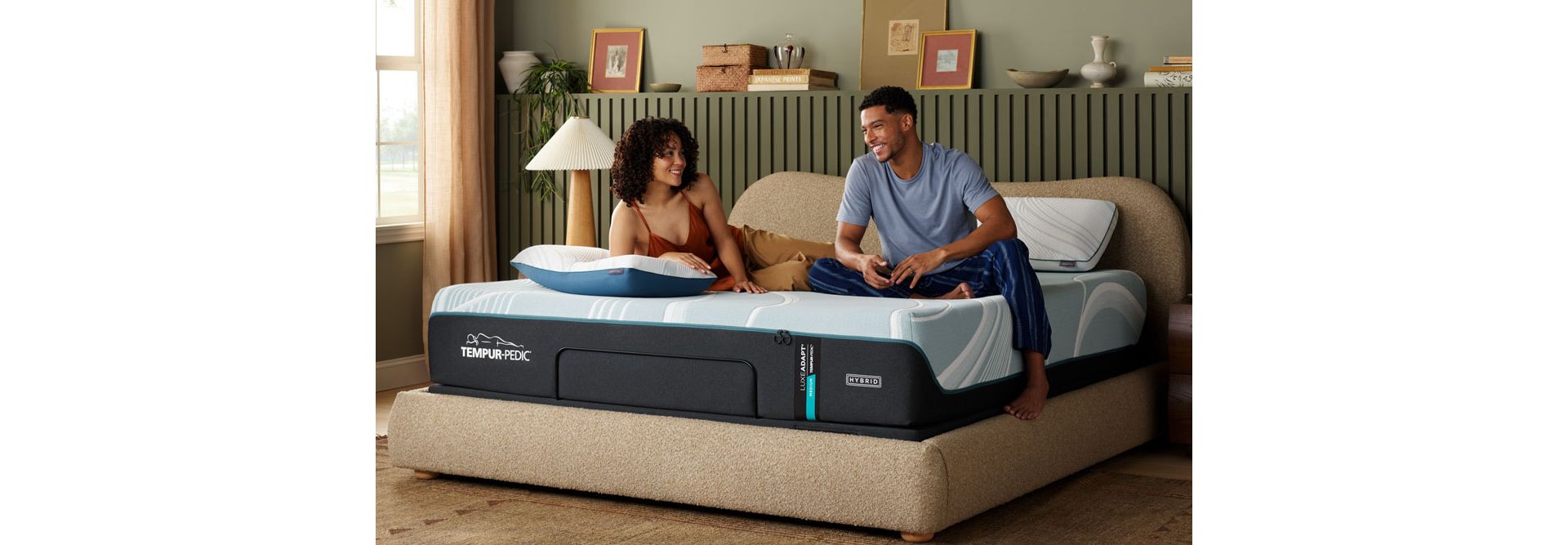 Couple relaxing on Tempur-Pedic Adapt Hybrid Mattress in well designed bedroom