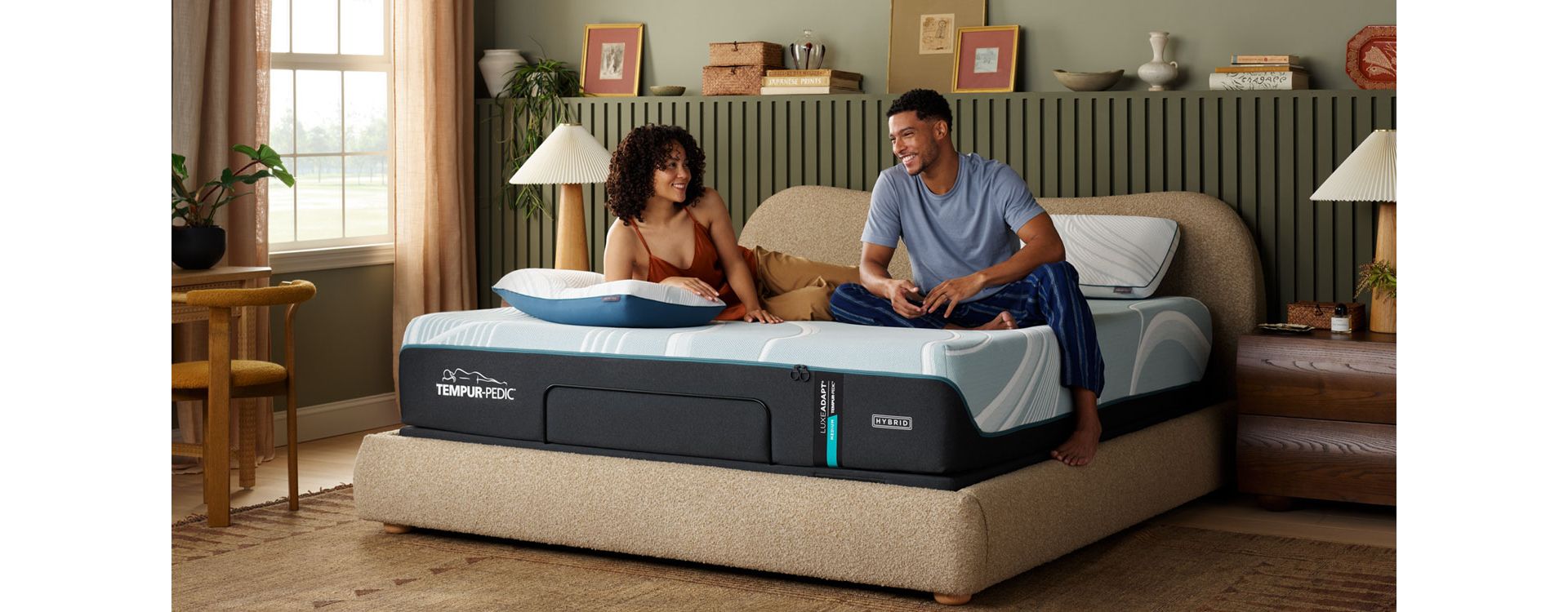 Couple relaxing on Tempur-Pedic Adapt Hybrid Mattress in well designed bedroom