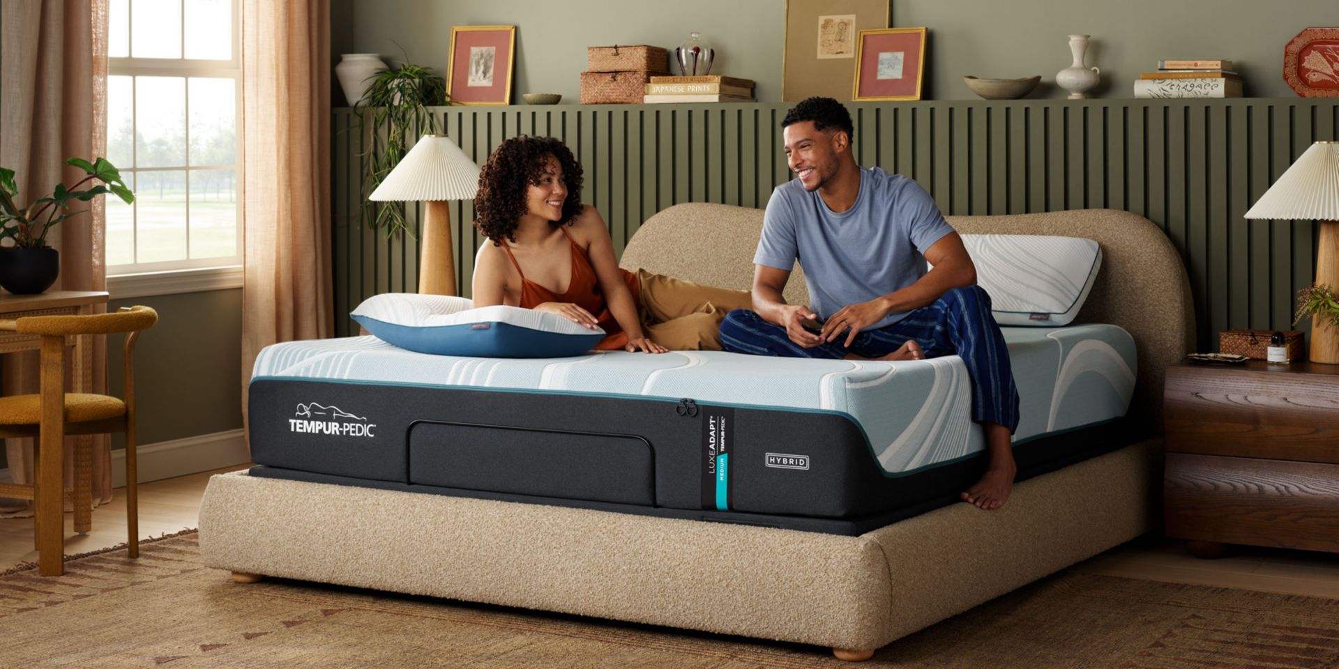 Couple relaxing on Tempur-Pedic Adapt Hybrid Mattress in well designed bedroom